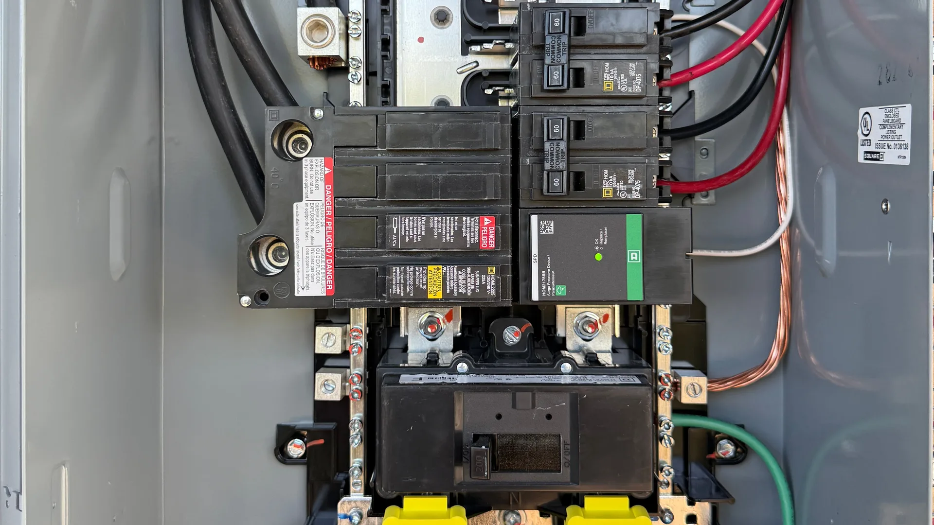 A whole-home surge protection device installed at a residential main breaker panel by American Electric Co, status indicator showing green